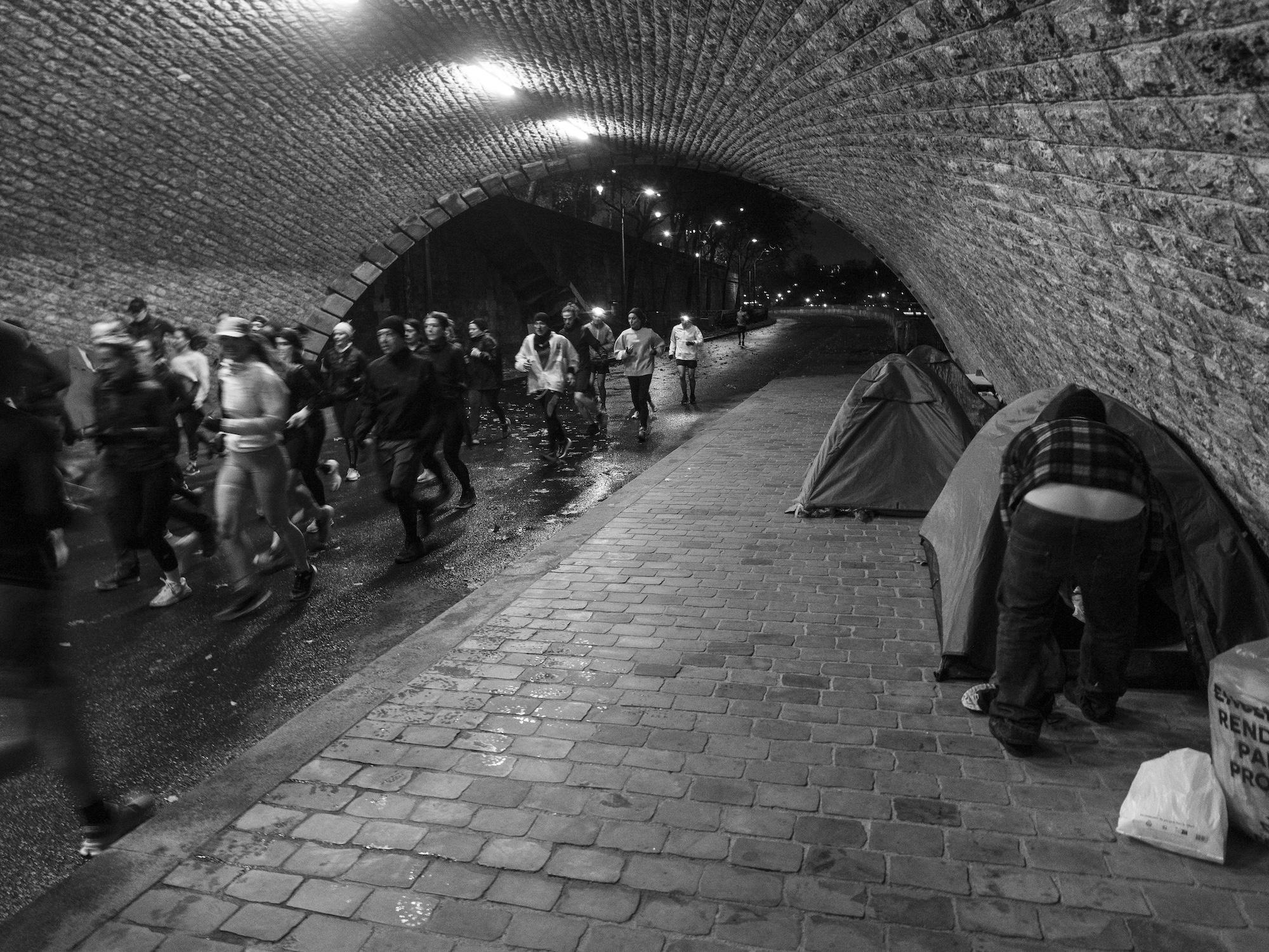 Sous les ponts de la capitale, les joggeurs du soir passent devant les campements sans y prêter attention.